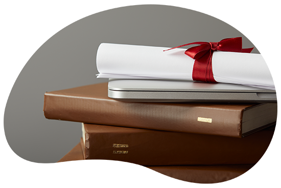 Rolled certificate with a red ribbon on a stack of books