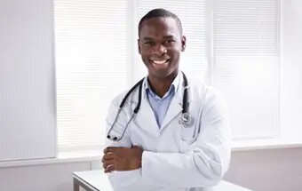 Smiling medical doctor in a white coat