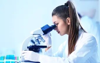 Medical technologist looking through a microscope