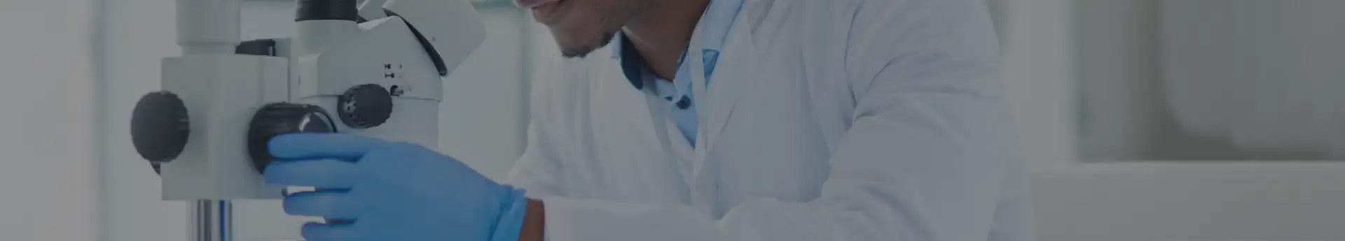 Medical technician with a microscope